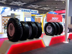 Heavy-duty industrial and OTR tyres displayed at a tyre exhibition, suitable for construction, mining, and industrial machinery in Kenya.